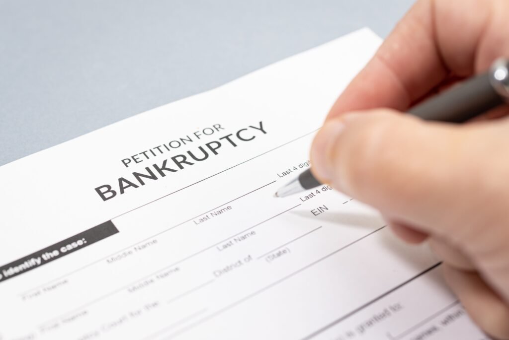 hand filling a bankruptcy form